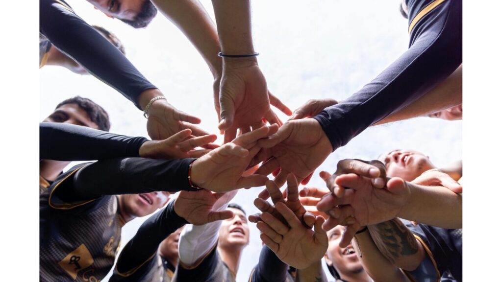 たくさんの人が手を重ねて一つになっている写真